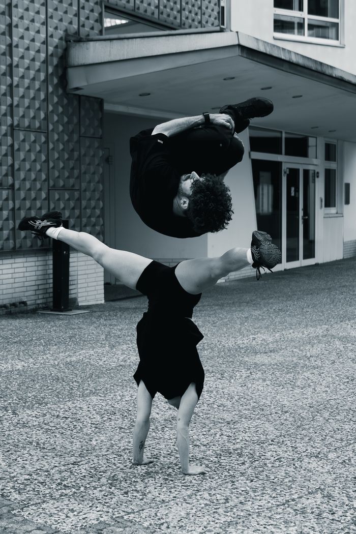 A stunning acrobatic performance captured outdoors in Berlin, showcasing strength and precision.